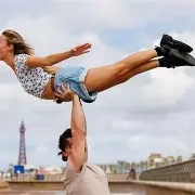 Couple performing dance lift symbolizing homeownership triumph despite mortgage decline