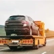 car being towed on flatbed after breakdown - home equity refinancing options